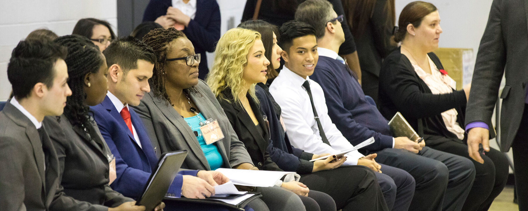 Students sitting in chairs at a conference