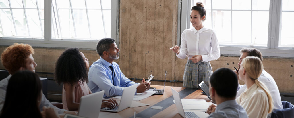 Woman speaking to a group of colleagues