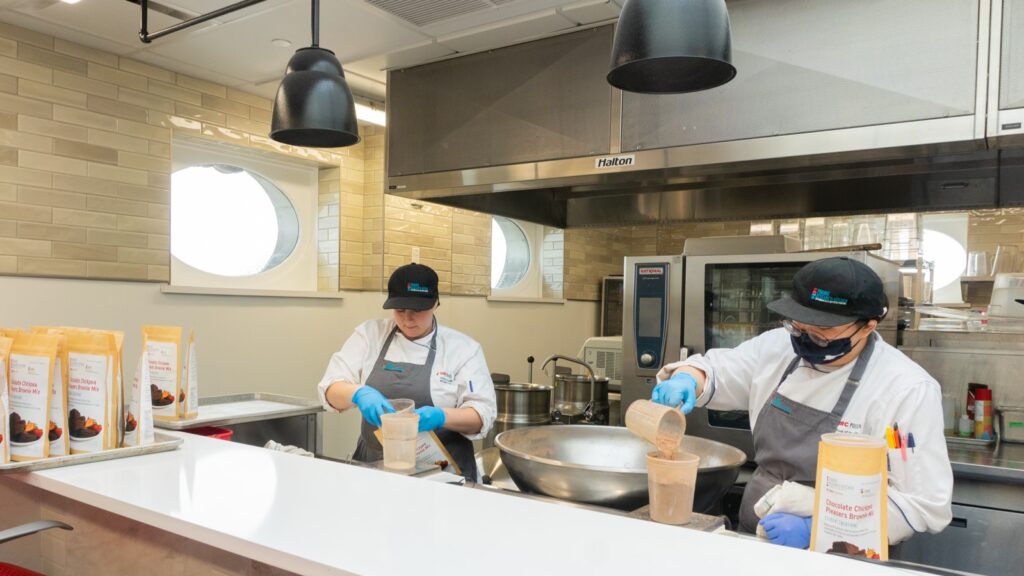 two people working in a commercial kitchen