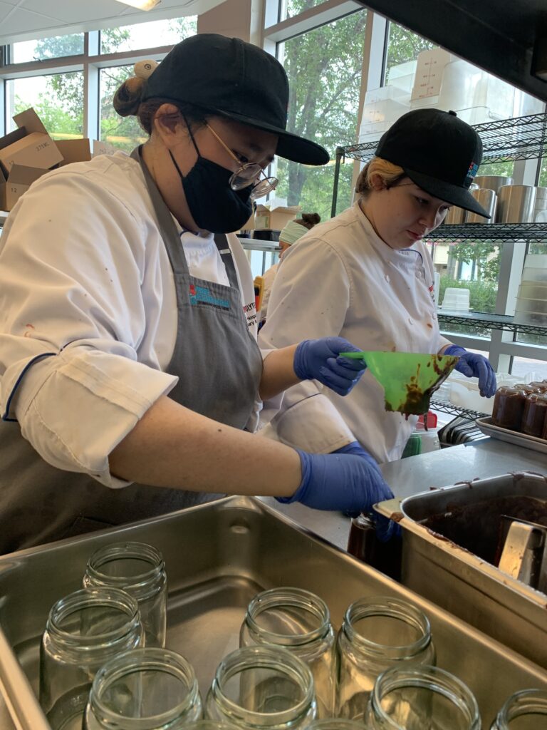 two people working in a kitchen