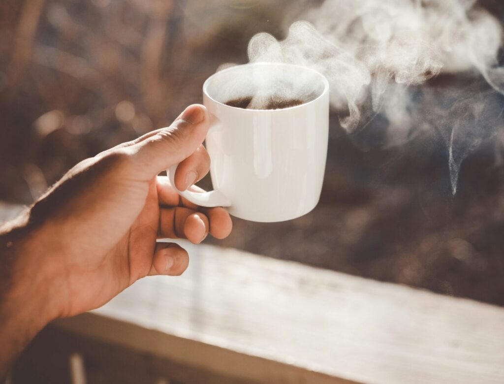 Person holding a cup of coffee