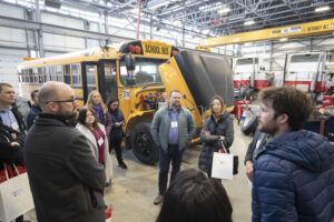 A group of visitors tours the Vehicle Technology & Energy Centre as part of the 20th anniversary of Research Partnerships & Innovation at RRC Polytech.