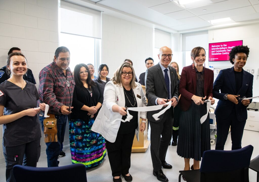 Stakeholders cutting ribbon at opening of RRC Polytech's Interdisciplinary Health and Community Services Simulation Centre.