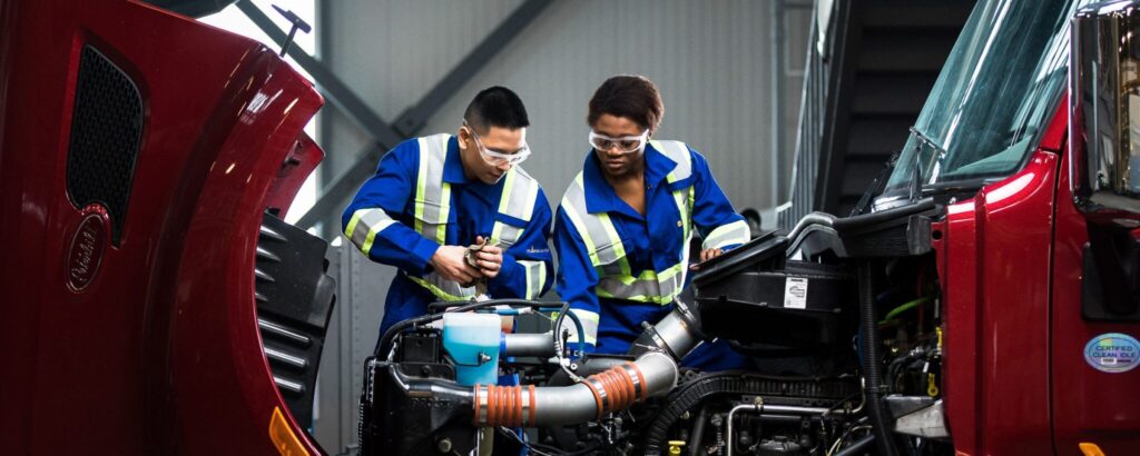 Two people working on a vehicle