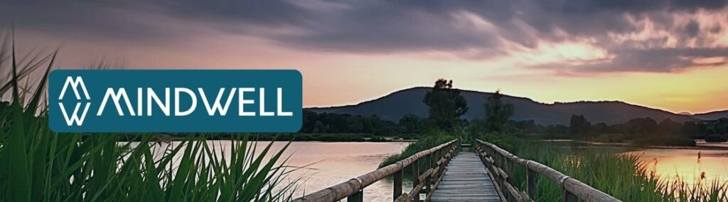 A dock on water at sunset with the MindWell logo.