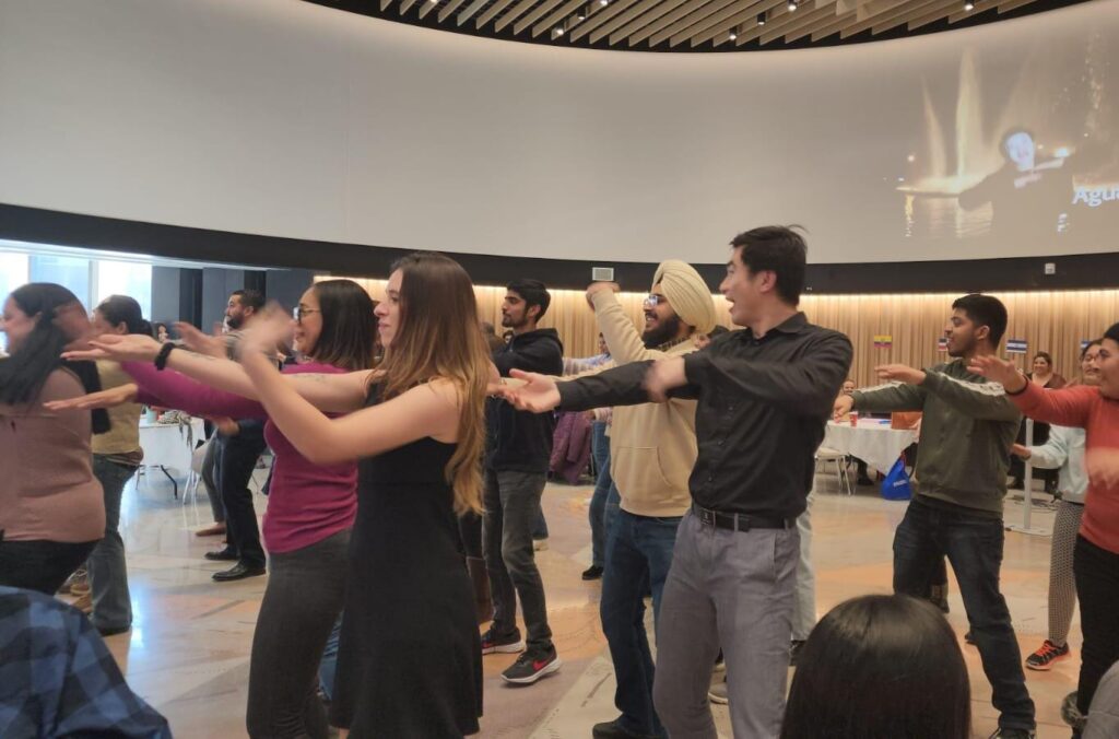 group of people learning latin dance moves.