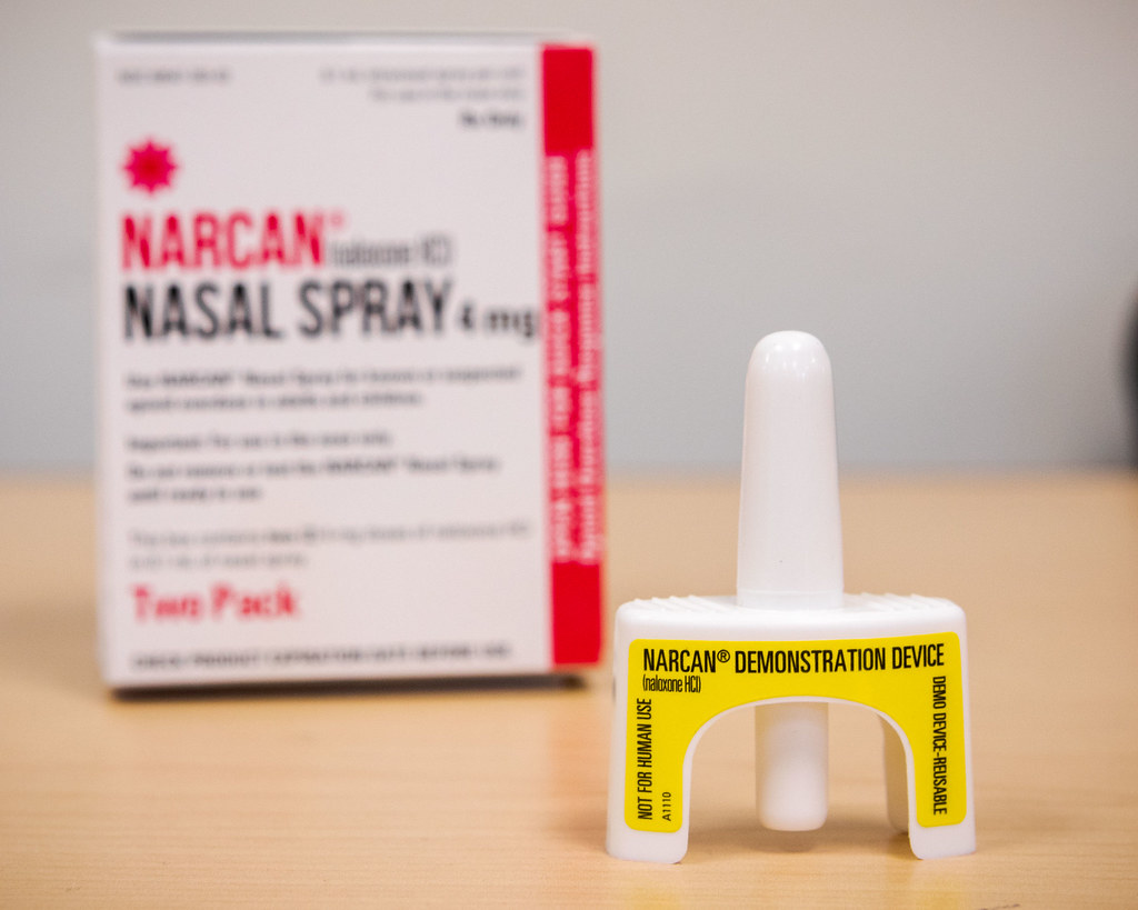 A Narcan nasal spray and its box sitting on a table