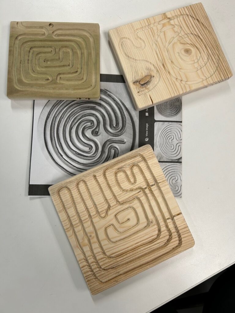 Three small wooden finger-labyrinths.