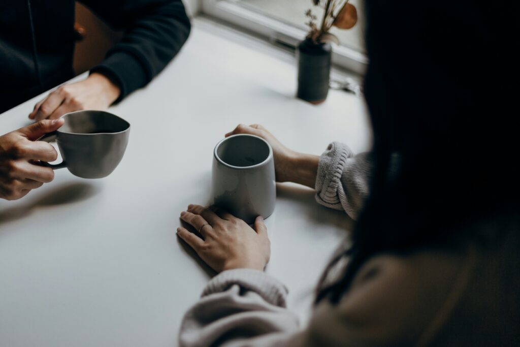 Two people chatting with coffee