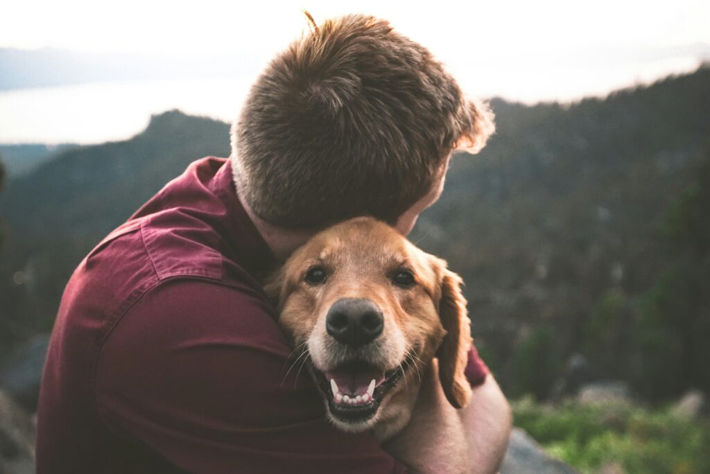 Person hugging a dog.