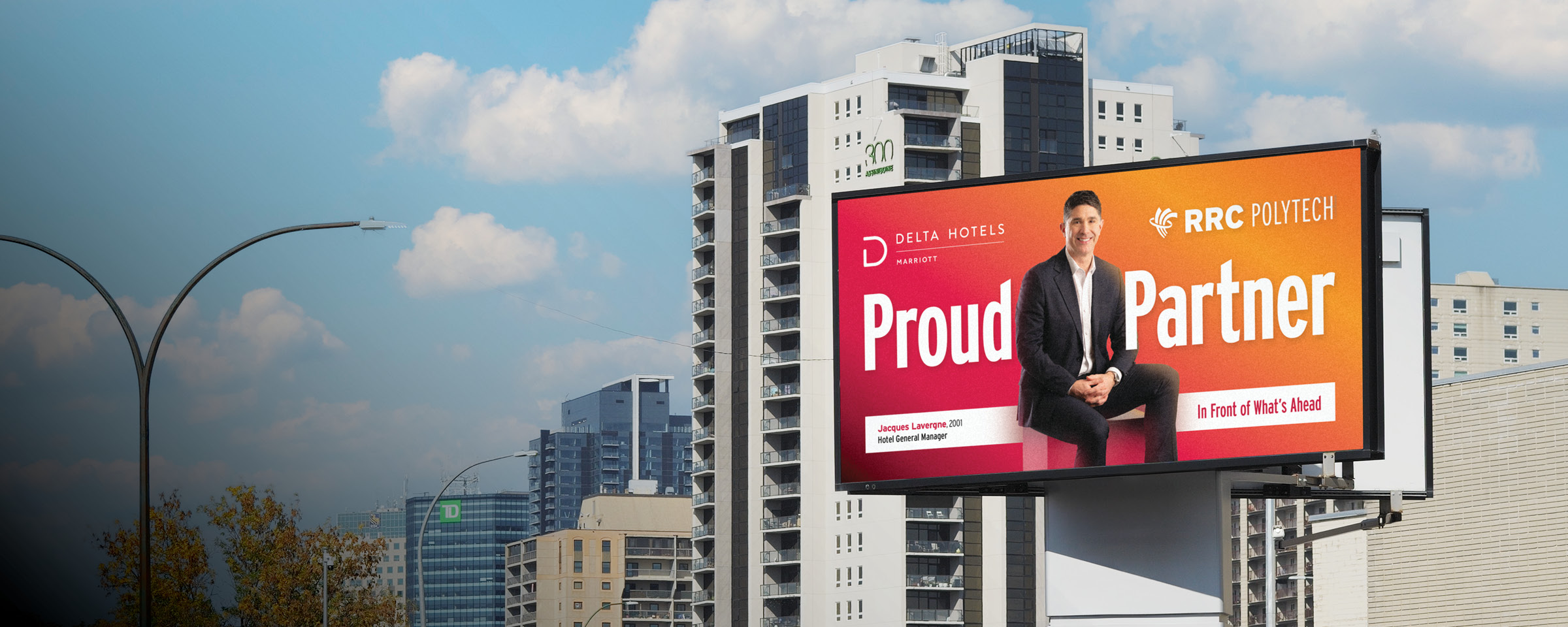 Winnipeg skyline with "Proud Partner" billboard of RRC Polytech graduate Jacques Lavergne.