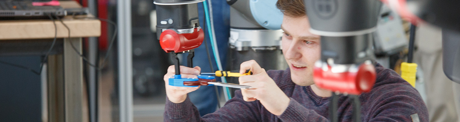 Student working on a machine in a shop