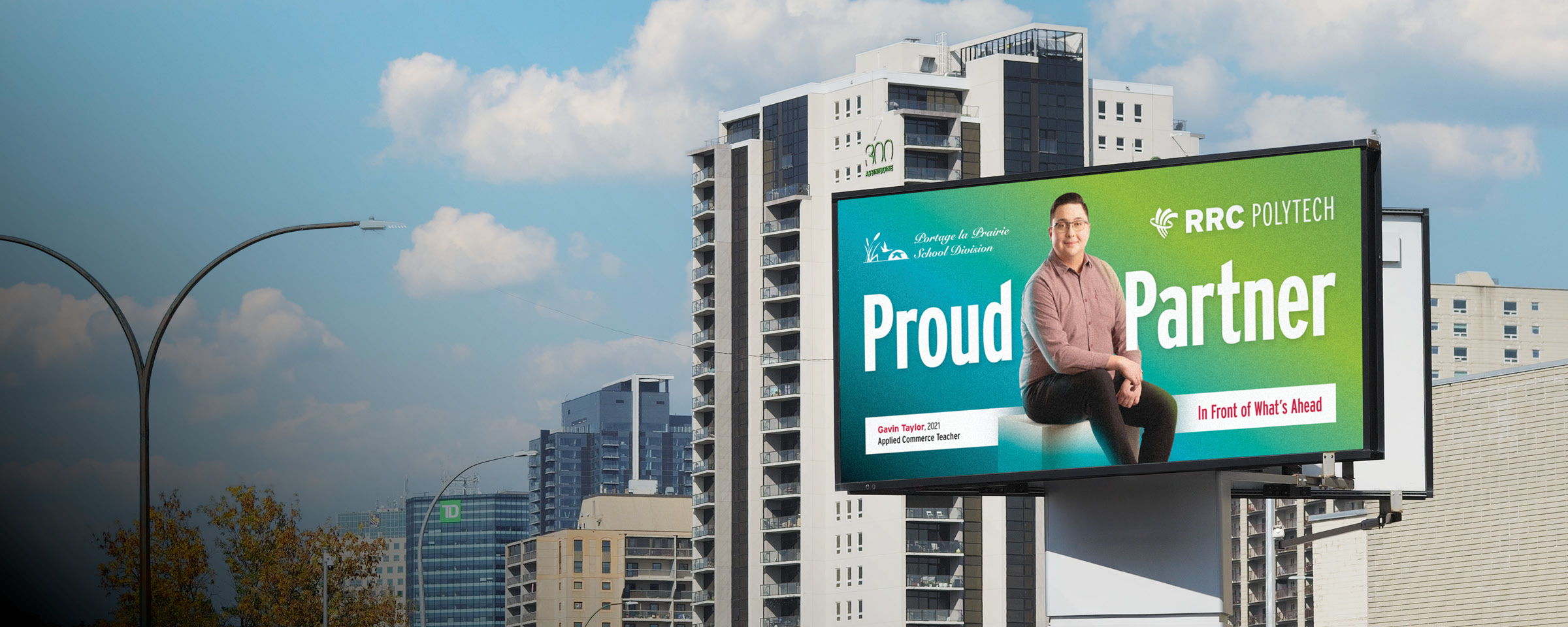 Winnipeg skyline with "Proud Partner" billboard of RRC Polytech graduate Gavin Taylor.